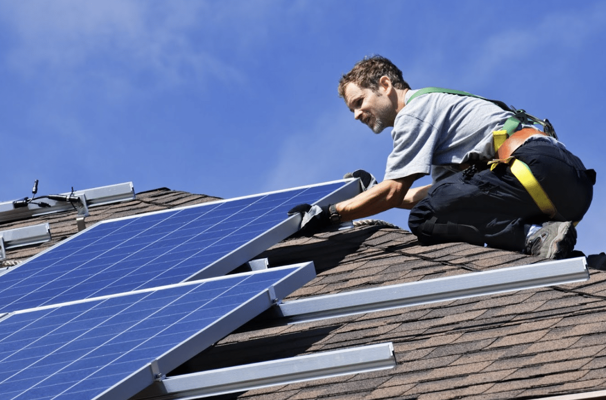 solar_installation Workers in safety gear installing a solar panel for a solar installation.